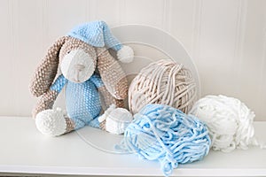 Toy knitted Doggy view from above. A soft toy made with your own hands. Children`s toys and knitting threads
