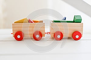 Toy locomotives trailers loaded with colored material