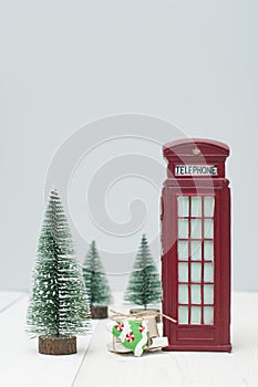 Toy London red phone booth, gifts and christmas trees