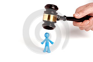 . Toy man and judge gavel isolated on white background. The concept of unfair judgments. Antipopular court. injustice