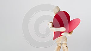 Toy manequin holding heart with copy space. High quality and resolution beautiful photo concept