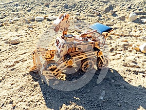 Toy Mars rover on the sandy ground