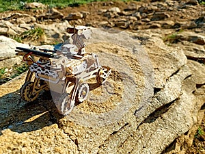 Toy Mars rover on a solid rock