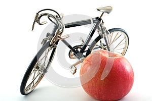 Toy metal bike and apple