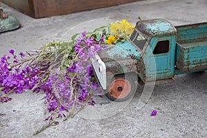 toy metal machine with traces of corrosion is on the concrete. Rust on the machine's gland