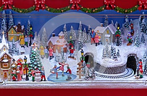 Toy miniature Christmas village with winter fun.