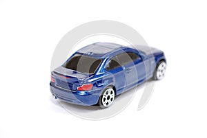 Toy model of the blue BMW 135 car of series of coupe on white background.