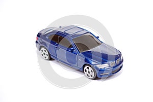 Toy model of the blue BMW 135 car of series of coupe on white background.