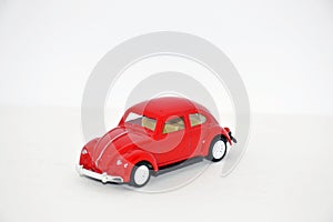 Toy model of a red retro car on a white background