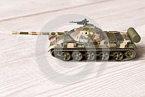 Toy model of the Soviet tank on a wooden table