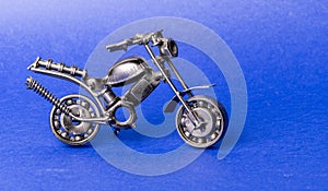 Toy model of a sports motorcycle on a blue background