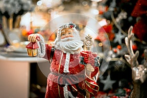 toy New Year`s decor and decorations for the home. santa with a lantern in his hands. macro photo. holiday christmas and happy new