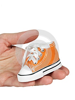 Toy on palm , sneaker