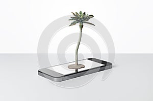 Toy palm tree on a smart phone