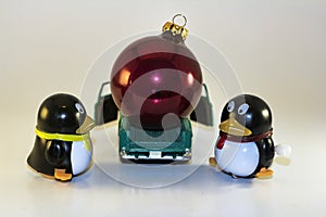 Toy Penguins Loading Xmas Ornament into Truck