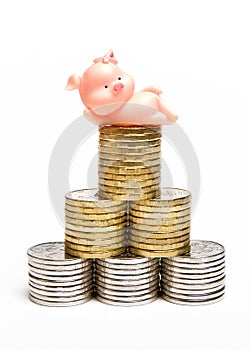 Toy pig lying on top of the coin tower