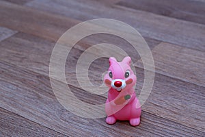 Toy pink rabbit on linoleum