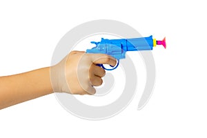 Toy pistol in a child's hand isolated on a white background. Gun on suction cups on a white background.