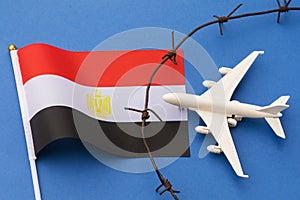 Toy plane, Egyptian flag and barbed wire on colored background, Egypt air border violation concept