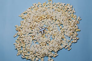 A toy plane over popcorn clouds and blue sky