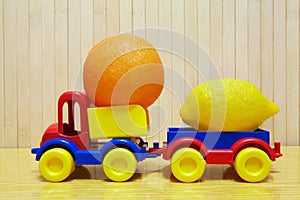 Toy plastic car with lemon and orange