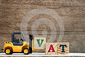 Toy plastic forklift hold block V to compose word vat