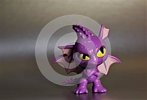 The toy is a purple dragon with yellow eyes