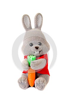 Toy rabbit with carrot isolated on white