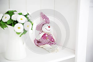 Toy rabbit on a white shelf