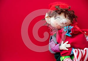 Toy rag doll on red background. Art soft focus