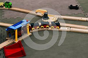 Toy railway. A wooden train with wagons rides on rails. Ecological toys for children