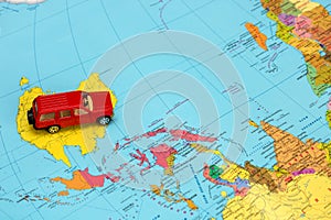 toy red car on the world map in Australia, caravanning