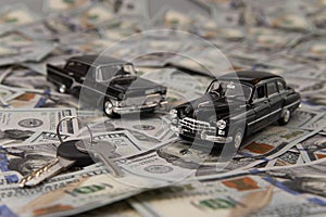 Toy retro cars on the background of dollar bills