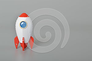 Toy rocket isolated on a grey background.The symbol for success is Start-up business, education and knowledge