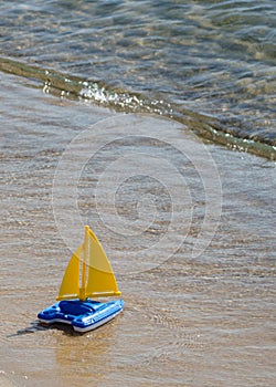 Toy sailboat at waters edge