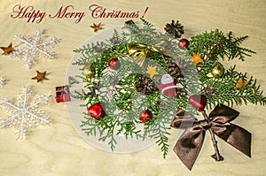 Toy Santa Claus,chocolate balls and hearts,cones and Happy Merry Christmas on the branch of a cypress tree