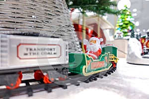 Toy Santa Claus on Polar Express Train on bright white Christmas eve