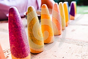 Toy set conical pieces of wood painted in colors for unstructured children`s games