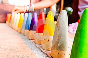 Toy set conical pieces of wood painted in colors for unstructured children`s games