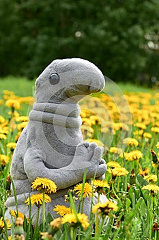 Toy sits in grass and flowers june photo