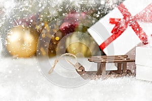 Toy sleigh and Christmas decorations as background
