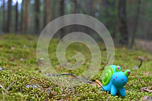 Toy snail on the moss