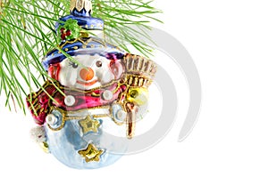 Toy snowman on the green fir-branch christmas decoration