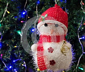 Toy snowman in red hat