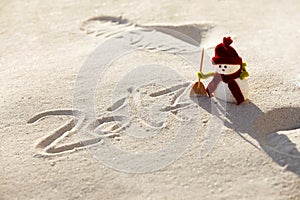 Toy snowman on the sand