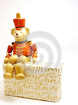 Toy soldier bear perched on Christmas gift
