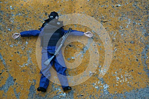 Toy soldier with a gas mask and a rifle on the background of a concrete slab