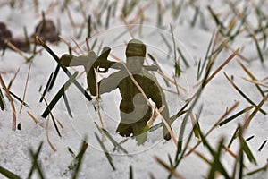 A Toy Soldier Resting His Rifle on His Shoulder in a Patch of Snow