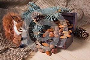 Toy squirrel and chest with nuts under the Christmas tree