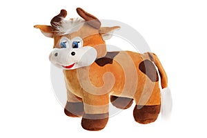 Toy stuffed cow puppet isolated at white background. Symbol of chinese new year.  Cuddly toy animal